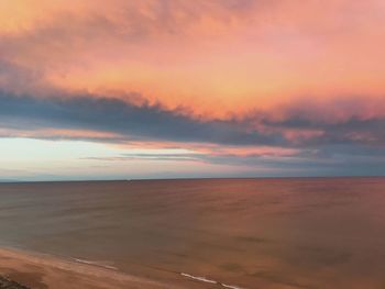 Scenic view of beach against sky during sunset