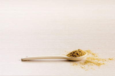 Close-up of bread in container against white background