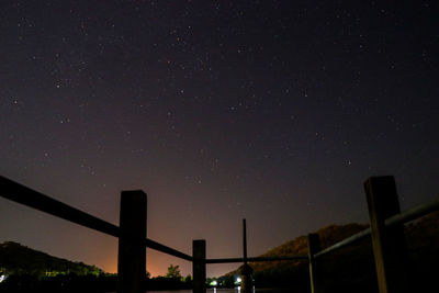 Low angle view of silhouette stars against sky at night