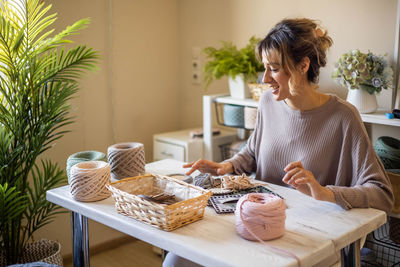 Smiling woman using laptop at home