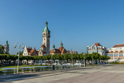 Buildings in city against blue sky