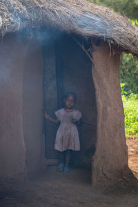 Full length of woman standing by tree