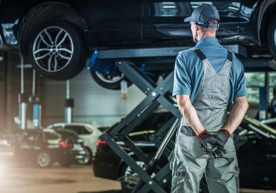 Rear view of mechanic at auto repair shop