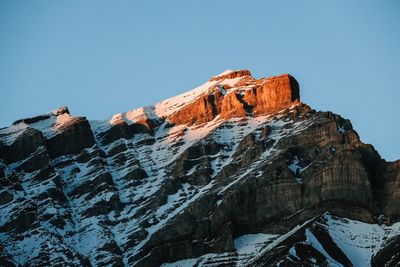 Low angle view of snowcapped mountain against sky