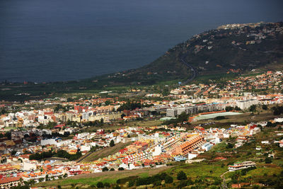 Aerial view of cityscape by sea