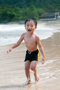 Portrait of happy boy playing on beach