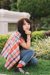 Portrait of woman sitting on field