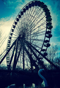 Low angle view of ferris wheel against sky