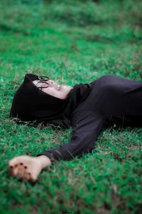 Woman lying on field