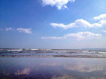 Scenic view of sea against cloudy sky