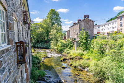 Bridge over river amidst buildings against sky