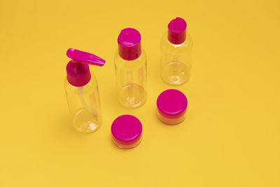 High angle view of medicines on yellow background