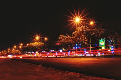 Illuminated light trails on city street at night