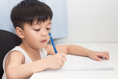 Midsection of boy holding table