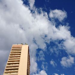 Low angle view of skyscraper against blue sky