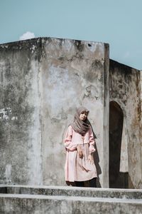 Woman standing against wall