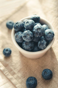 High angle view of blueberries in bowl on table