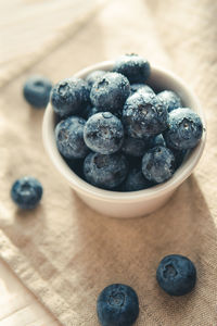 High angle view of blueberries in bowl on table