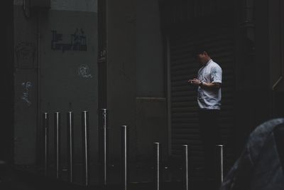 Side view of young man sitting in building