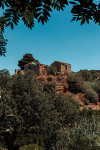 Low angle view of castle against clear blue sky