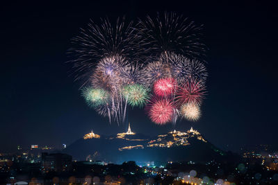 Low angle view of firework display at night