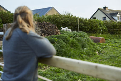 Rear view of man against house
