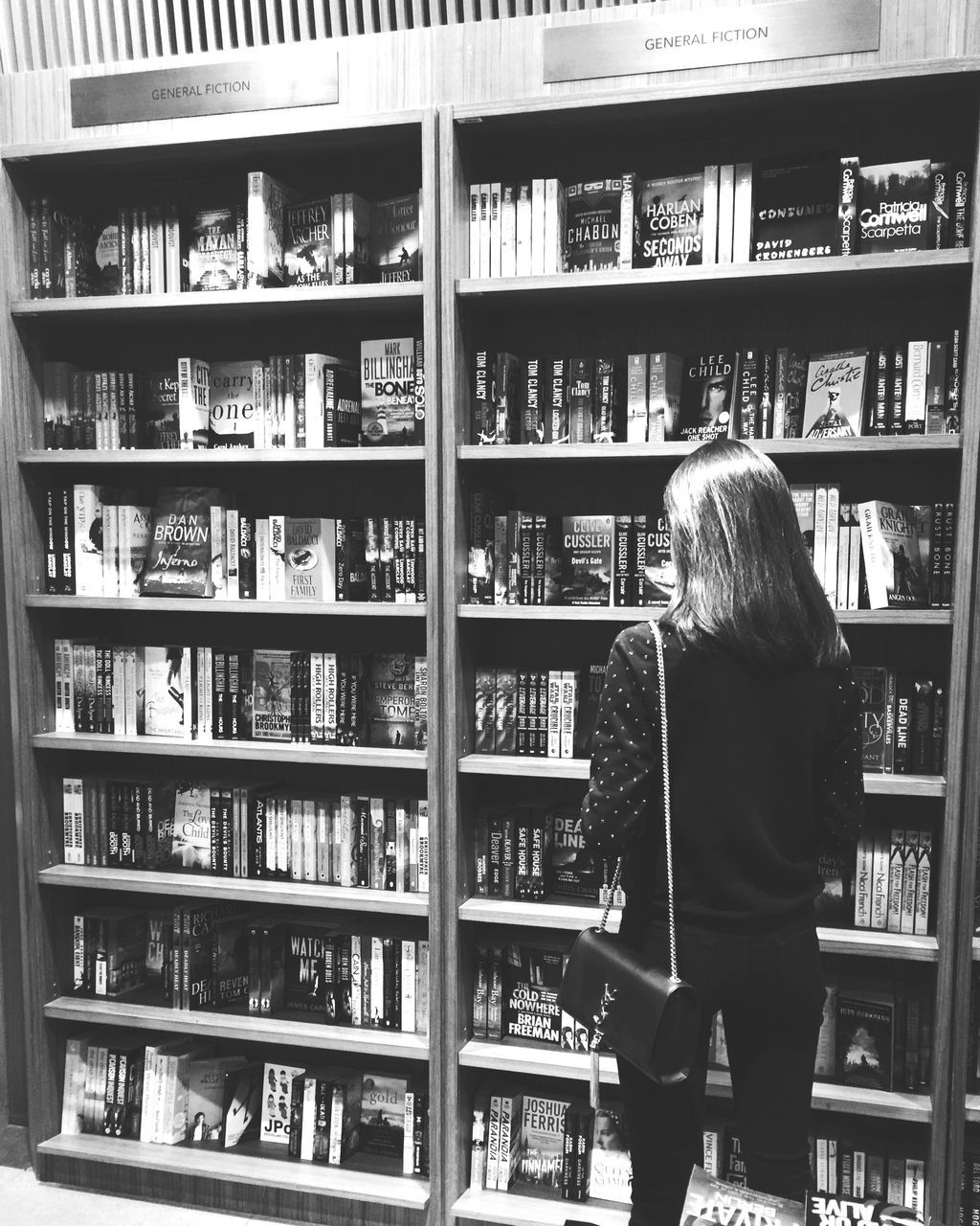 shelf, one person, bookshelf, rear view, book, shelves, library, real people, standing, indoors, women, lifestyles, retail, choice, young women, large group of objects, young adult, day, one woman only, adult, people