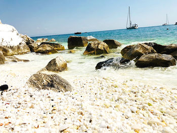 Rocks on beach against sky