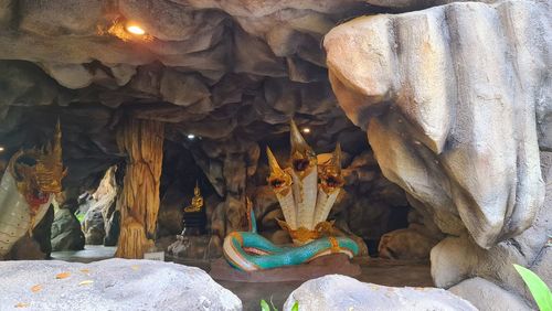 Close-up of buddha statue on rock