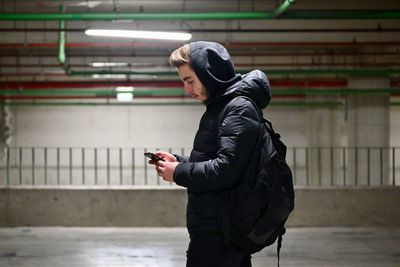 Side view of man using mobile phone