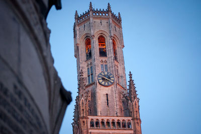 Low angle view of clock tower against sky