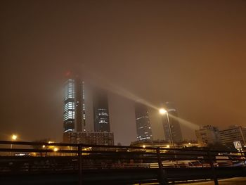 Low angle view of illuminated buildings against sky at night