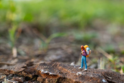 Miniature people backpackers walking with friends 