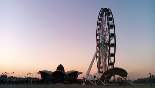 Low angle view of ferris wheel against sky