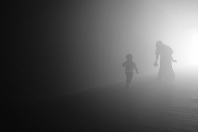 Silhouette girl standing on field