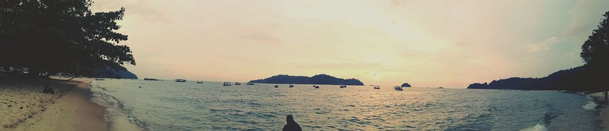 Scenic view of beach against sky during sunset