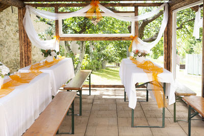 Empty chairs and table in porch