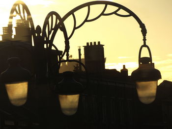 Close-up of electric lamp against sky