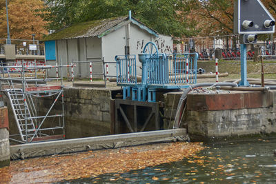 Houses by river against building
