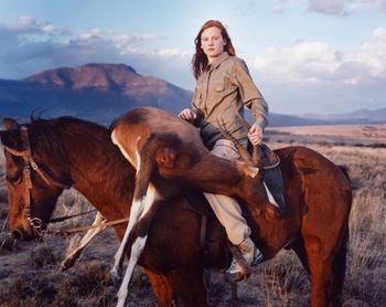 Full length of smiling woman standing on land