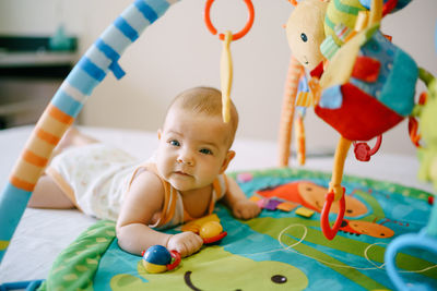 Portrait of cute boy playing with toy at home