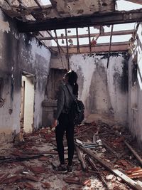 Full length of woman standing in abandoned house