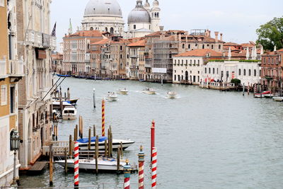 Boats sailing in grand canal against santa maria della salute