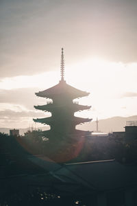 Silhouette of building against sky during sunset