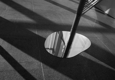 High angle view of shadow on tiled floor