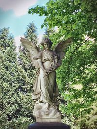 Low angle view of statue against trees