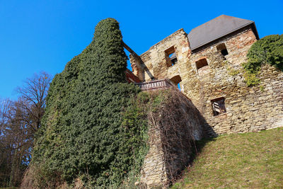 Low angle view of old building against blue sky