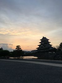 Silhouette of building against sky during sunset