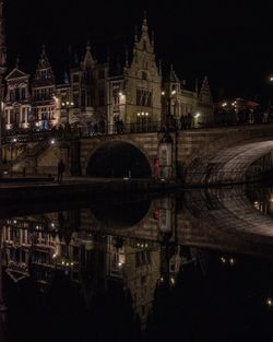 Reflection of illuminated buildings on river at night