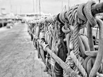 Close-up of rope tied to bollard at harbor